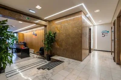 a lobby of an office building with plants at Hotel Spot Family Suites in Porto