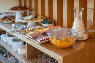 a table with a bowl of fruit on a shelf at Hotel Spot Family Suites in Porto