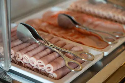a tray of hot dogs with a pair of scissors at Hotel Spot Family Suites in Porto