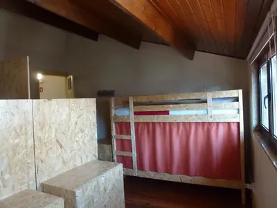 a room with two bunk beds and a window at Canvas Atelier Hostel in Porto