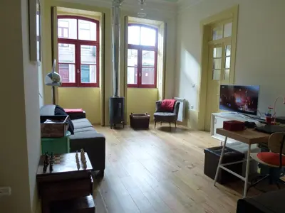 a living room with a couch and a tv at Canvas Atelier Hostel in Porto