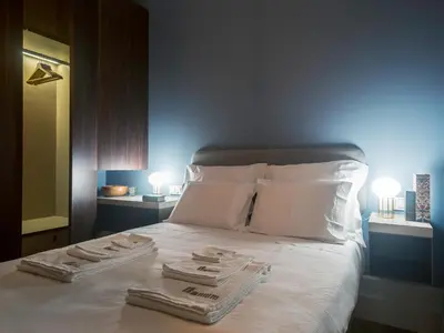 a bedroom with a bed with two towels on it at Domum 2 in Porto