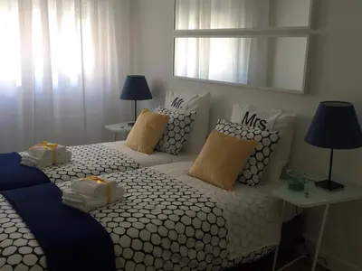 a bedroom with two beds with pillows and a mirror at Apartamento Da Lapa in Porto