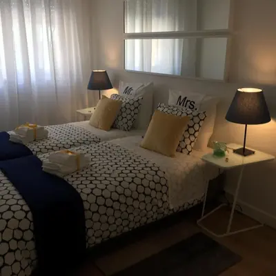a bedroom with a large white bed with pillows at Apartamento Da Lapa in Porto