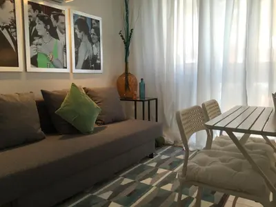 a living room with a couch and a table at Apartamento Da Lapa in Porto