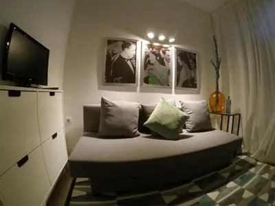 a bedroom with a bed with pillows and a flat screen tv at Apartamento Da Lapa in Porto