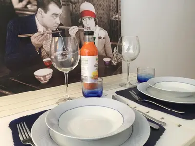 a table with a bottle of wine and plates and glasses at Apartamento Da Lapa in Porto