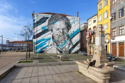 a large mural of a man on the side of a building at Goabio Apartment 3 Riverview in Porto