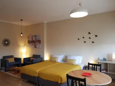 a bedroom with a bed and a chair at Cozy loft in downtown in Porto