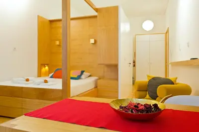a room with a bed and a bowl of flowers on a table at 45 Flores: Rua das Flores/S.Bento in Porto