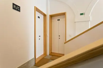 a hallway with two doors in a building at 45 Flores: Rua das Flores/S.Bento in Porto