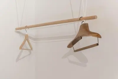 a wooden hanger hanging from a white wall at GuestReady - Mezzanine at the Bridge in Porto