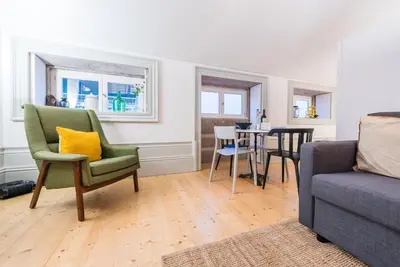 a living room with a couch and a table at GuestReady - Mezzanine at the Bridge in Porto