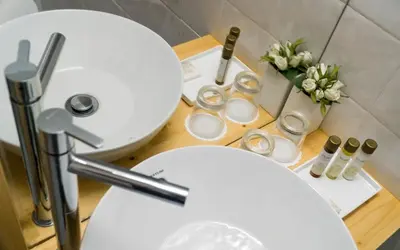a bathroom with two white toilets and a sink at Ribeiredge Guest House in Porto