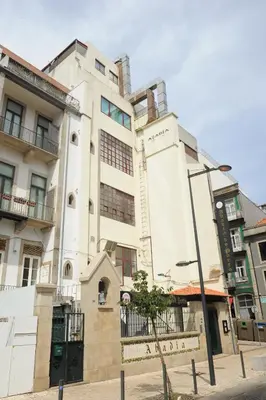a tall white building on a city street at Abbey Apartments City Center Bolhão in Porto
