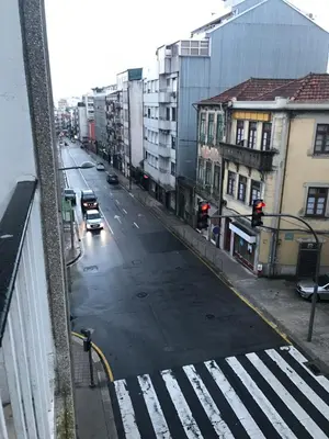 an empty city street with traffic lights and cars at AP da Baixa in Porto