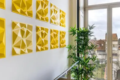 a wall with yellow triangles on it next to a window at GuestReady - Urban oasis with private balcony in Porto