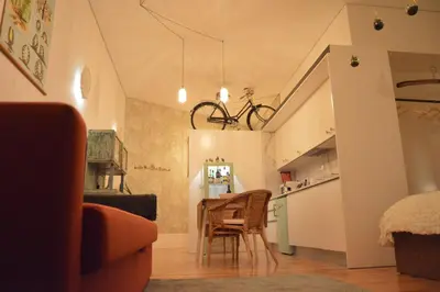 a living room with a table and a kitchen at Oporto Old In New in Porto