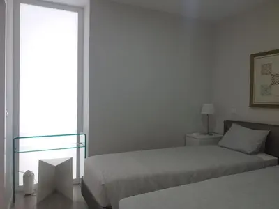 a bedroom with two beds and a window at H2O Porto Ribeira in Porto