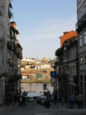 a group of people walking down a street in a city at H2O Porto Ribeira in Porto