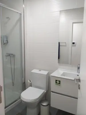 a bathroom with a toilet and a sink and a shower at H2O Porto Ribeira in Porto