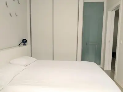 a bedroom with a white bed and a mirror at H2O Porto Ribeira in Porto