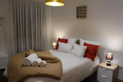 a bedroom with a large bed with towels on it at Casa São Dinis in Porto