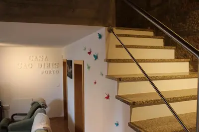 a staircase in a house with a sign on the wall at Casa São Dinis in Porto