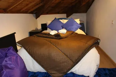 a bedroom with a bed with two towels on it at Casa São Dinis in Porto