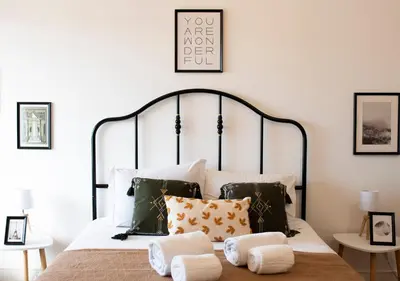 a bedroom with a bed with pillows on it at Oporto Trindade Residence in Porto