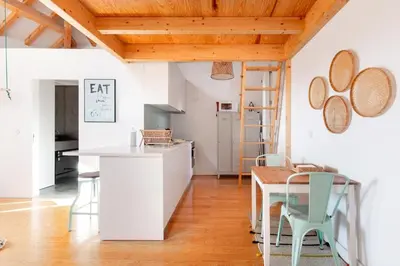 a kitchen and dining room with a table and chairs at Loft 72 in Porto