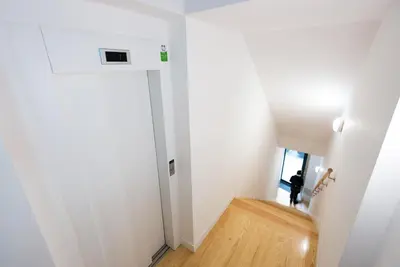 a hallway with a door and a wooden floor at Loft 72 in Porto