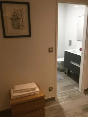 a bathroom with a sink and a toilet and a mirror at Central & Charming Clérigos Appartments in Porto