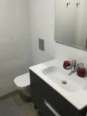 a bathroom with a white sink and a toilet at Central & Charming Clérigos Appartments in Porto