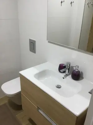 a bathroom with a sink and a toilet and a mirror at Central & Charming Clérigos Appartments in Porto
