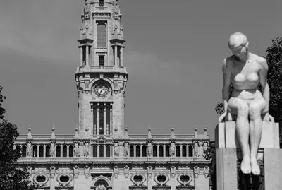 a statue in front of a building with a clock tower at Welcome to My City 