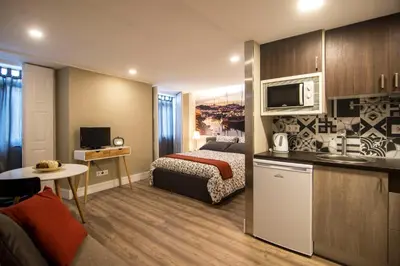 a hotel room with a bed and a kitchen at Welcome to My City 