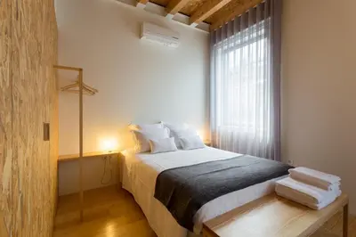 a bedroom with a large bed and a window at Casa da Figueiroa in Porto
