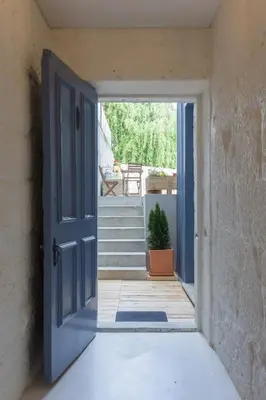 an open door leading to a porch with stairs at Casa da Figueiroa in Porto