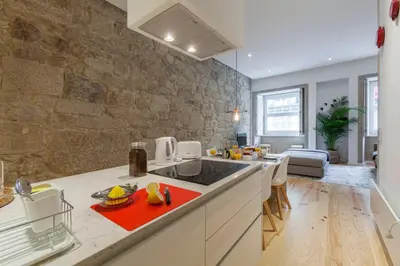 a kitchen with a sink and a counter top at Old Stone Flats by Host Wise in Porto