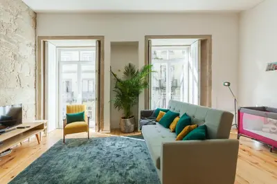 a living room with a couch and a rug at Old Stone Flats by Host Wise in Porto