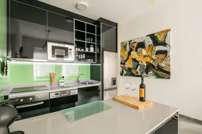 a kitchen with a table with a bottle of wine on it at Merc Porto Ribeira`s Place in Porto