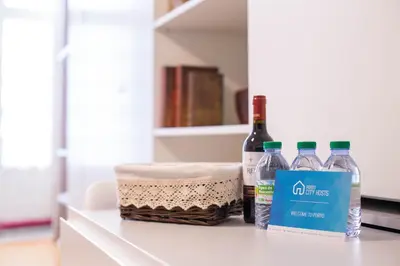 three bottles of water and a basket on a counter at Almada Story Apartments by Porto City Hosts in Porto