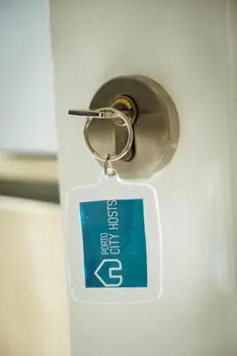 a key chain with a sign attached to a door at Almada Story Apartments by Porto City Hosts in Porto