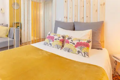 a bedroom with a bed with two pillows on it at D&S - Ribeira Premium Apartments in Porto