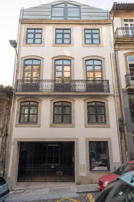 a large white building with windows and a balcony at Almada Domus in Porto