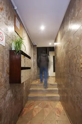 a person walking down the stairs in a hallway at Studio DOWNTOWN in Porto