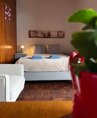a bedroom with a bed and a couch at Studio DOWNTOWN in Porto