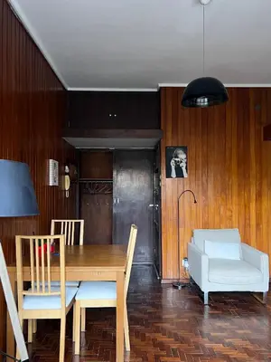 a dining room with a wooden table and chairs at Studio DOWNTOWN in Porto