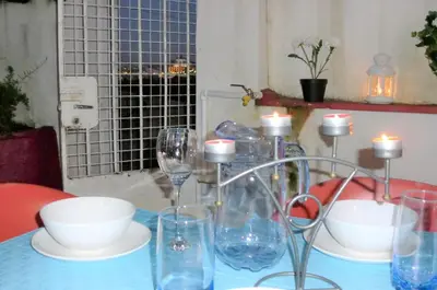 a table with wine glasses and bowls and candles at Mira Porto House in Vila Nova de Gaia